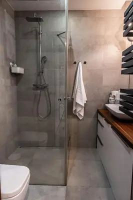 a shower with a glass door in a bathroom at Smart Executive in Kraków