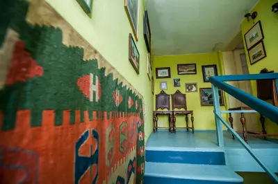 a hallway with stairs and a wall with a mural at Dwór w Odonowie in Odonów