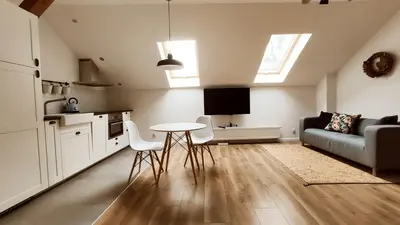 a kitchen and living room with a table and a couch at Zamkowa 9 Apartment with a view on Wawel Castle by Homeprime in Kraków