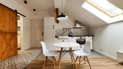 a kitchen with a white table and white chairs at Zamkowa 9 Apartment with a view on Wawel Castle by Homeprime in Kraków