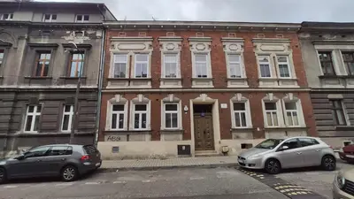 two cars parked in front of a brick building at Zamkowa 9 Apartment with a view on Wawel Castle by Homeprime in Kraków