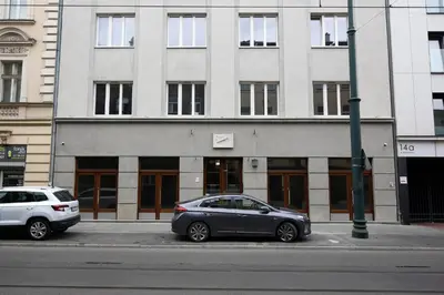 two cars parked in front of a building at Partnerapart Rakowicka 14 in Kraków