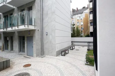 a view of a building with benches in a courtyard at Partnerapart Rakowicka 14 in Kraków