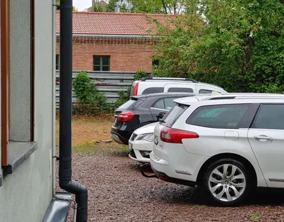 a row of parked cars parked next to a building at 999 Aparthostel in Kraków
