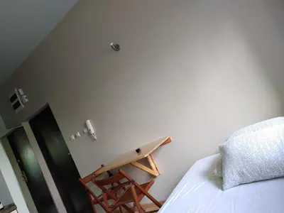 a bedroom with a surfboard on the wall next to a bed at 999 Aparthostel in Kraków