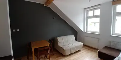 a living room with a white couch and a table at 999 Aparthostel in Kraków