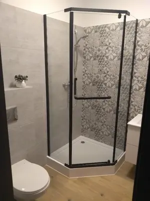 a shower stall in a bathroom with a toilet at Orange Apartament in Wadowice
