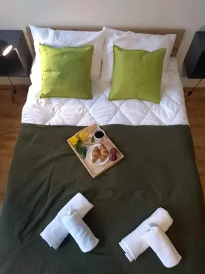 a tray of food on a bed with a plate of food at Orange Apartament in Wadowice