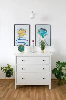 a white dresser in a room with two pictures at Discover Krakow Apartments - 3 Rakowicka St - Classic Apartments near Main Station - Netflix in Kraków