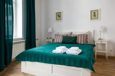 a bedroom with a bed with towels on it at Discover Krakow Apartments - 3 Rakowicka St - Classic Apartments near Main Station - Netflix in Kraków
