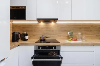 a kitchen with a stove and a counter top at W Parku Lotników Apartments Tauron Arena by Noclegi Renters in Kraków