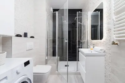 a bathroom with a shower and a toilet and a sink at W Parku Lotników Apartments Tauron Arena by Noclegi Renters in Kraków