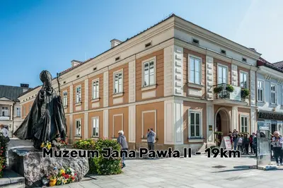 a large building with a statue in front of it at Miodowy Raj in Targanice
