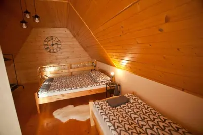a room with a bed in a wooden cabin at Babia Chata in Zawoja