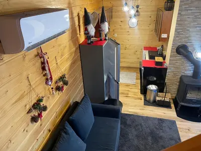 a living room with a couch and a television at Babia Chata in Zawoja