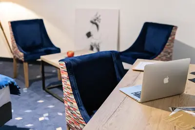 a table with a laptop computer on top of it at Ilkus Hotel & Restaurant in Krze