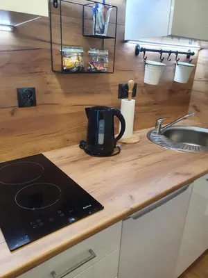 a coffee maker sitting on a counter next to a sink at Moti Apartments in Kraków