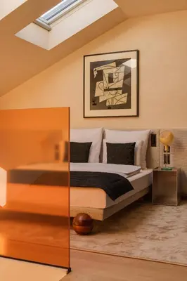 a bedroom with a white bed and a chair at Warszauer Hotel in Kraków