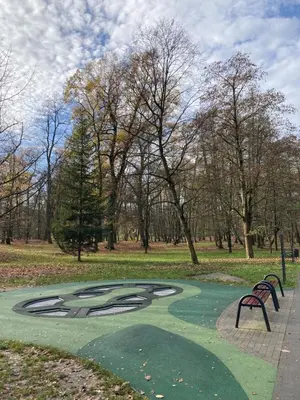 a putting green in a park with a bench at Let’s Dream Apartment 68 m2 in Kraków