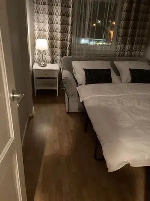 a room with two beds and a table with a lamp at Let’s Dream Apartment 68 m2 in Kraków