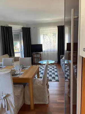 a living room with a table and a dining room at Let’s Dream Apartment 68 m2 in Kraków