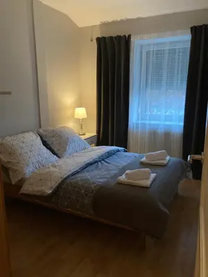 a bedroom with a bed with two towels on it at Let’s Dream Apartment 68 m2 in Kraków