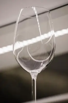 a empty wine glass sitting on a table at Riva Verona Apartment by Renters Prestige in Kraków