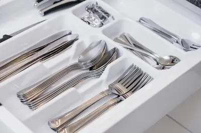 a white tray with silver utensils in a sink at Riva Verona Apartment by Renters Prestige in Kraków