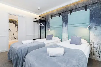 two beds in a room with blue and white at Riva Verona Apartment by Renters Prestige in Kraków