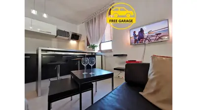 a living room with a couch and a table with wine glasses at Apartament 33 in Kraków