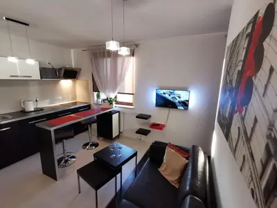 a living room with a couch and a table at Apartament 33 in Kraków