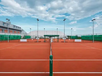 a tennis court with a net on a tennis court at Tennis & Country Club Hotel in Giebułtów