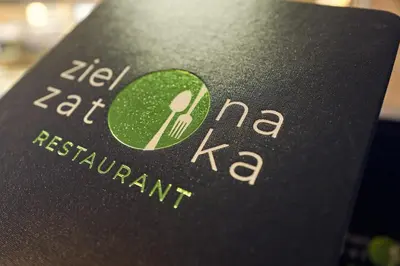 a book with the name of a restaurant on it at Tennis & Country Club Hotel in Giebułtów