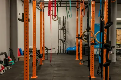 a gym with rows of squat racks at Tennis & Country Club Hotel in Giebułtów
