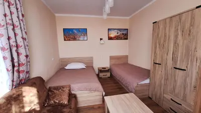 a small room with two beds and a couch at Mieszkanko na peryferiach in Chrzanów