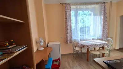 a small kitchen with a table and a window at Mieszkanko na peryferiach in Chrzanów