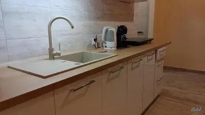a kitchen counter with a sink and a appliance at Mieszkanko na peryferiach in Chrzanów