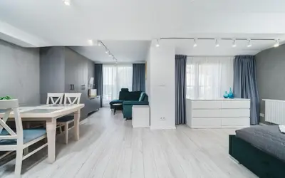 a living room with a table and a dining room at Ice Apartments in Kraków