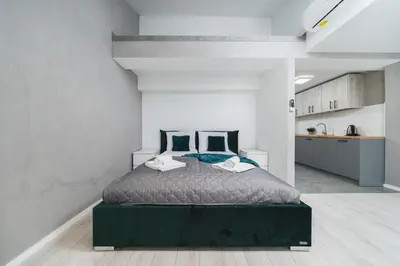 a bedroom with a large bed in a room at Ice Apartments in Kraków