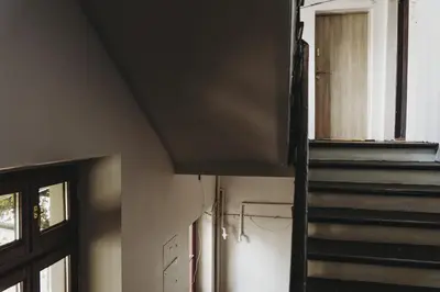 a room with a staircase next to a window at Kieszonka dla singla in Kraków