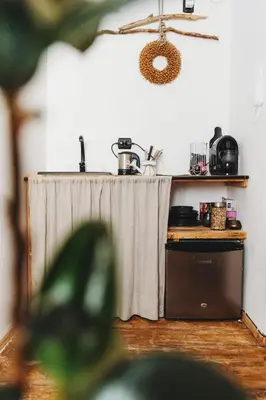 a kitchen with a table with a curtain on it at Kieszonka dla singla in Kraków