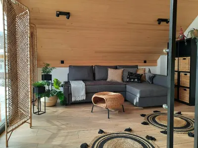 a living room with a couch and a table at Zawobaja in Zawoja