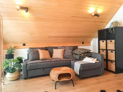 a living room with a couch and a wooden wall at Zawobaja in Zawoja