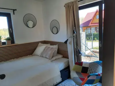 a bedroom with a bed and a window at Zawobaja in Zawoja