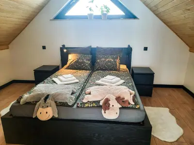 a bedroom with a bed with a dog laying on it at Zawobaja in Zawoja