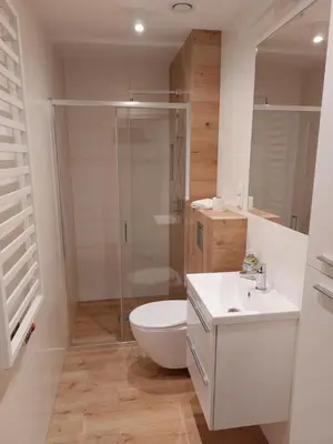 a bathroom with a shower and a toilet and a sink at Sleep In Center in Kraków