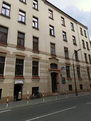 a building with a bike parked in front of it at Sleep In Center in Kraków