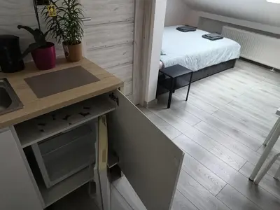 a small room with a bed and a desk at Sleep In Center in Kraków