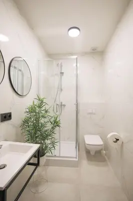 a bathroom with a shower and a toilet and a sink at Hotel pod Wieliczką in Gdów