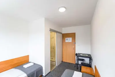 a bedroom with a bed and a desk and a table at Hotel pod Wieliczką in Gdów